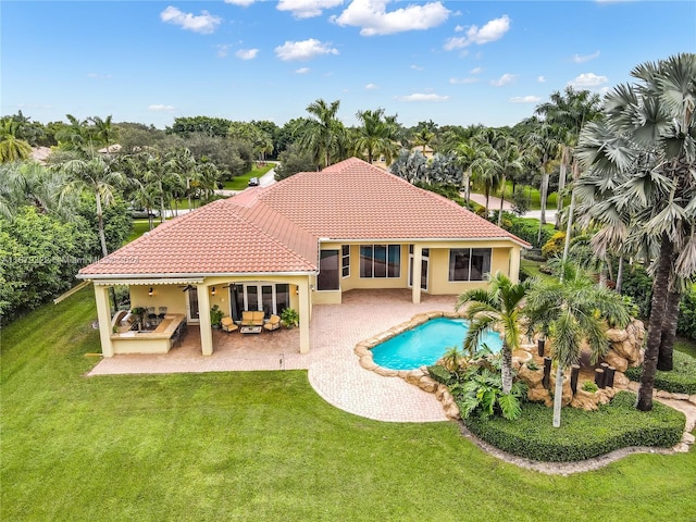 view of swimming pool with a patio and a yard