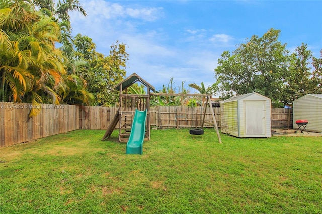 view of play area with a storage unit and a lawn