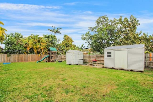 view of yard featuring a shed and a playground