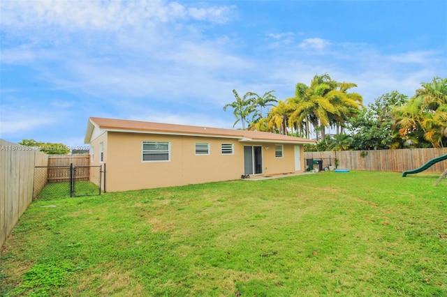 rear view of house with a yard