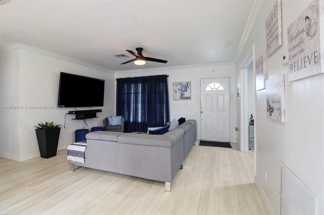 living room with crown molding, light hardwood / wood-style flooring, and ceiling fan