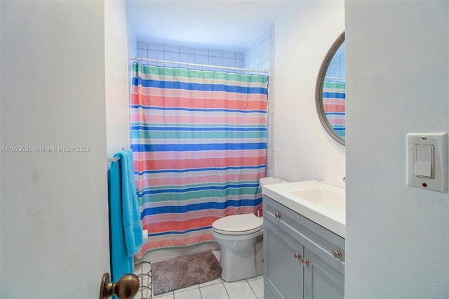 bathroom with a shower with shower curtain, vanity, toilet, and tile patterned floors