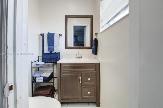 bathroom with tile patterned flooring, vanity, and toilet