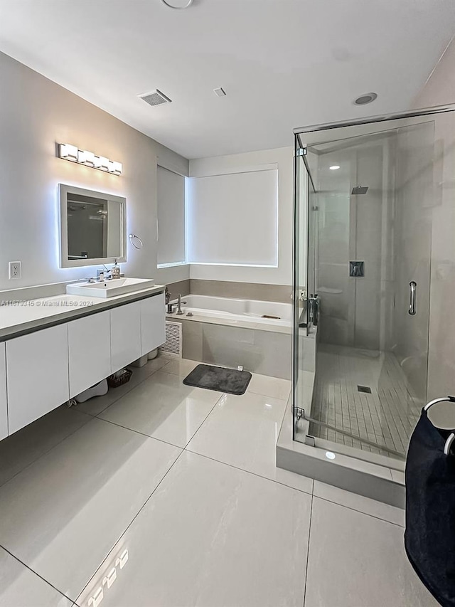 bathroom featuring vanity, independent shower and bath, and tile patterned floors