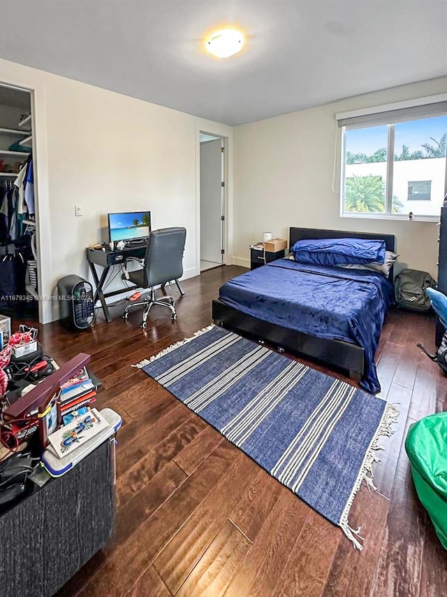 bedroom with a closet and dark hardwood / wood-style floors