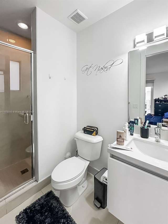 bathroom featuring vanity, toilet, tile patterned flooring, and an enclosed shower