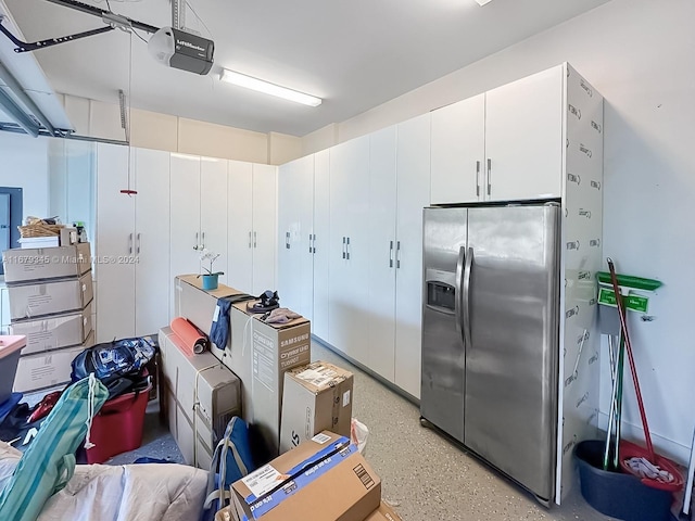 interior space featuring a garage door opener and stainless steel fridge