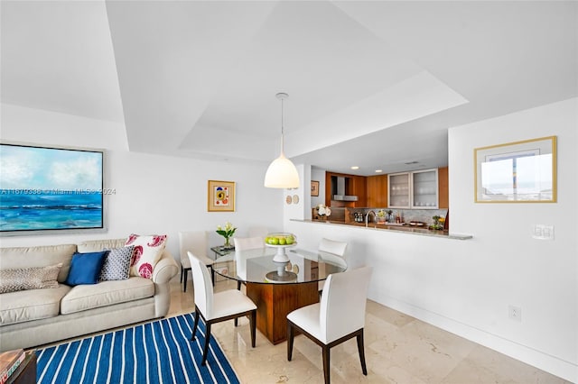 dining area featuring a tray ceiling and plenty of natural light