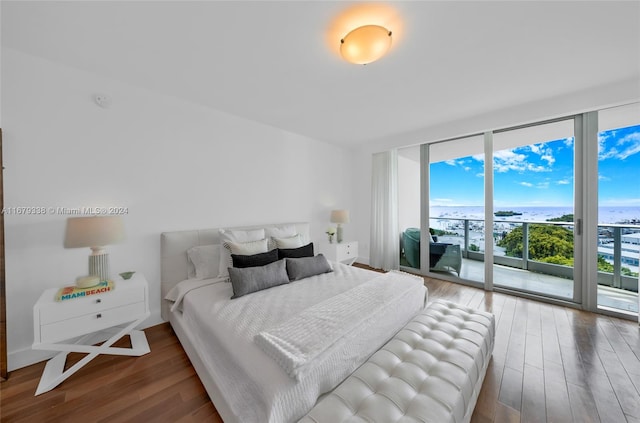 bedroom with wood-type flooring, access to outside, and floor to ceiling windows