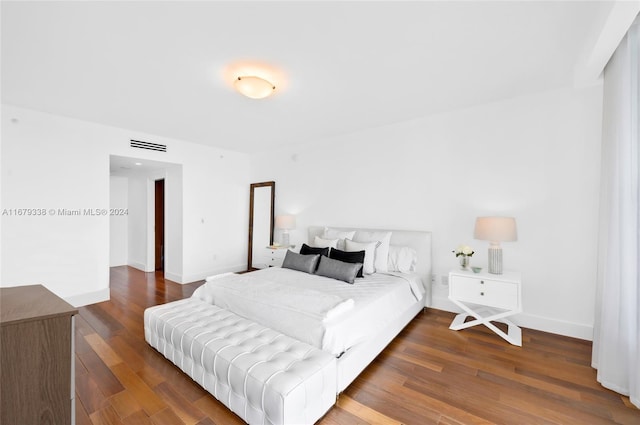 bedroom with dark hardwood / wood-style floors