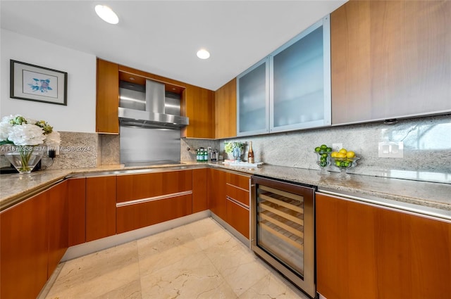 kitchen featuring decorative backsplash, wine cooler, and range hood