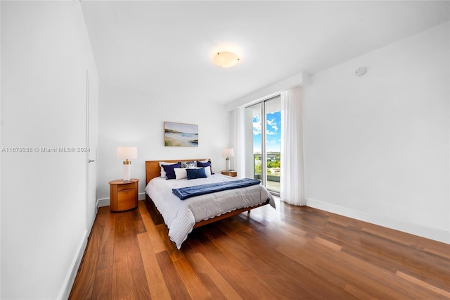 bedroom featuring hardwood / wood-style floors and access to exterior