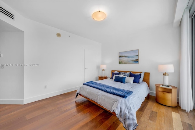 bedroom with hardwood / wood-style flooring