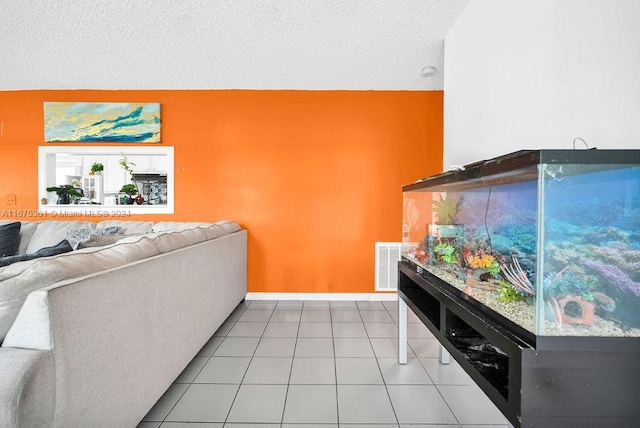 tiled living room featuring a textured ceiling