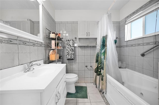 full bathroom featuring shower / bath combo, toilet, tile patterned flooring, vanity, and tile walls