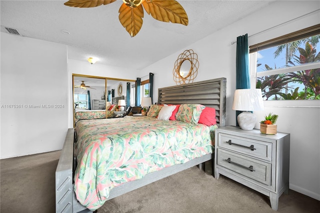 bedroom with carpet, a textured ceiling, a closet, and ceiling fan