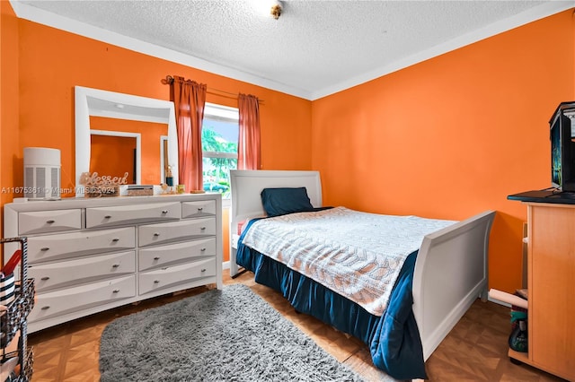 bedroom featuring crown molding and a textured ceiling