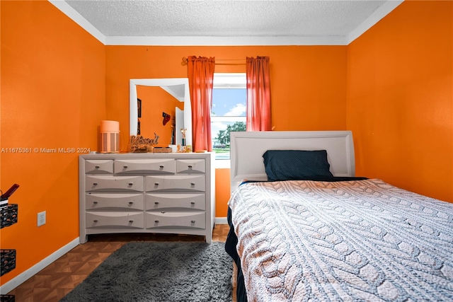 bedroom featuring crown molding, a textured ceiling, and parquet floors