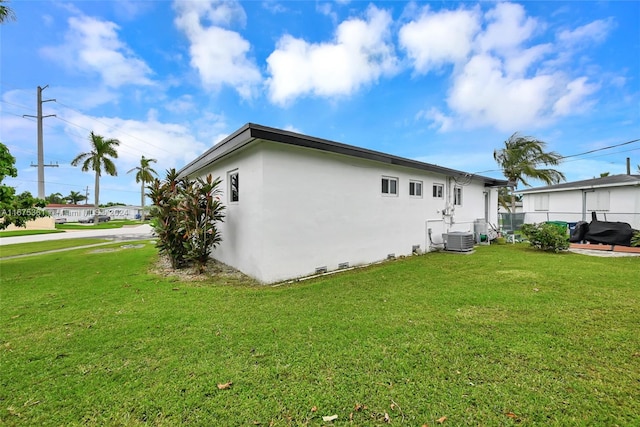 view of home's exterior with a yard and cooling unit