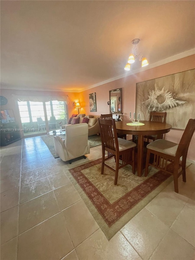 dining space with ornamental molding, a chandelier, and tile patterned floors