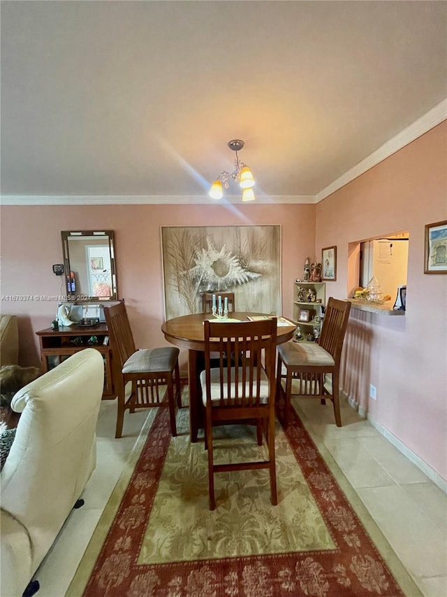 dining space featuring crown molding, a notable chandelier, and tile patterned flooring