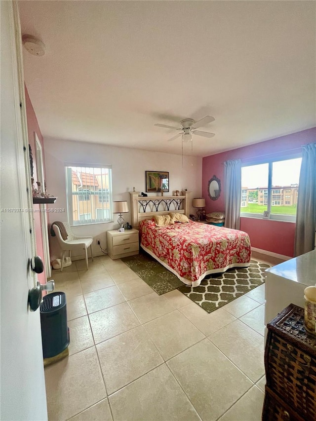 tiled bedroom featuring ceiling fan