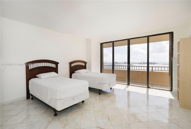 bedroom with expansive windows and access to outside