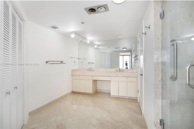 bathroom featuring vanity and a shower with shower door