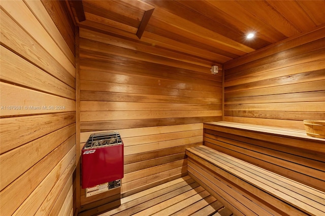 view of sauna / steam room featuring wooden walls, wooden ceiling, and wood-type flooring