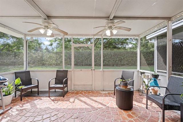 sunroom / solarium featuring ceiling fan