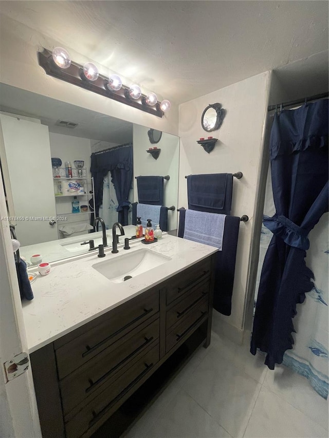 bathroom with vanity and tile patterned floors