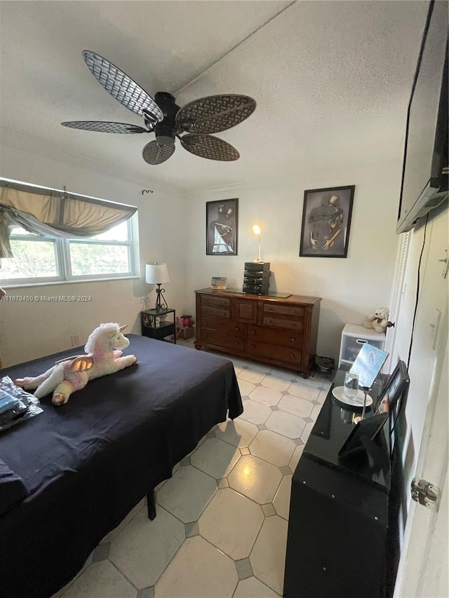 bedroom with pool table, a textured ceiling, and ceiling fan