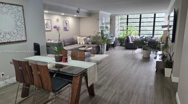 dining space with crown molding and hardwood / wood-style floors