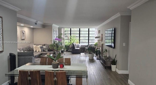 dining space with hardwood / wood-style floors and ornamental molding