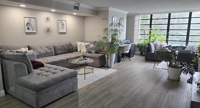 living room featuring wood-type flooring and ornamental molding