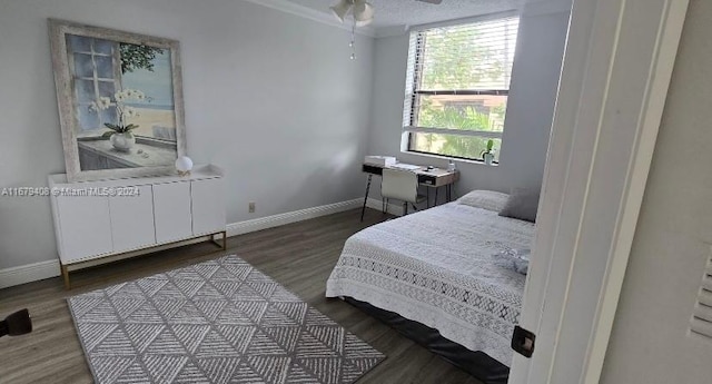 bedroom featuring radiator heating unit, hardwood / wood-style flooring, ceiling fan, and crown molding