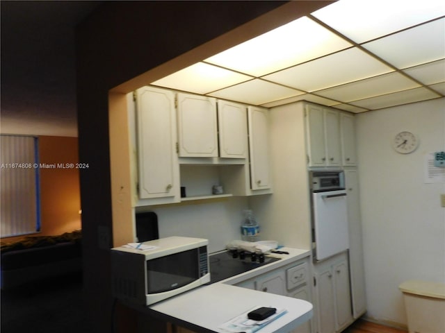 kitchen with white cabinets and white appliances