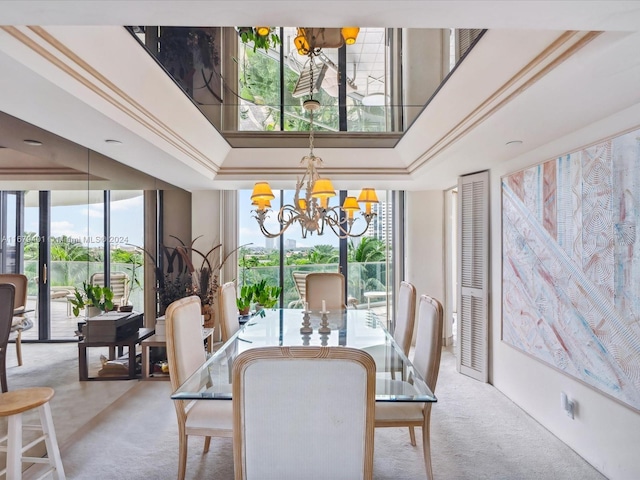 dining room with an inviting chandelier, ornamental molding, and a high ceiling