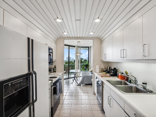 2800 Island Blvd Unit 702, Aventura, FL 33160 - kitchen with white appliances, a sink, light countertops, white cabinets, and recessed lighting