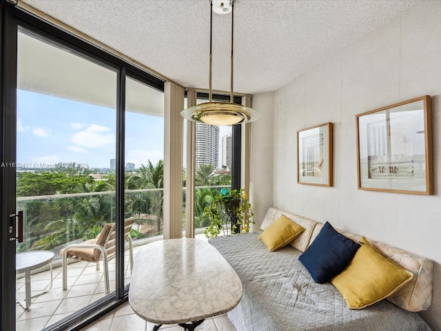 2800 Island Blvd Unit 702, Aventura, FL 33160 - bedroom with a textured ceiling, access to exterior, expansive windows, and light tile patterned floors