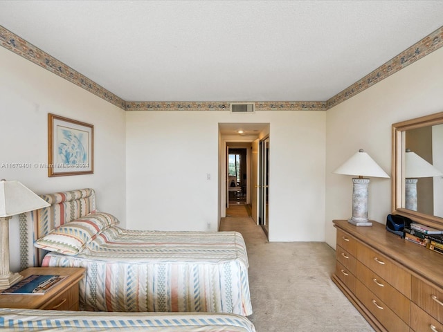 carpeted bedroom with a textured ceiling