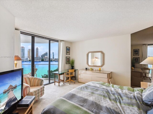 2800 Island Blvd Unit 702, Aventura, FL 33160 - bedroom featuring access to exterior, floor to ceiling windows, carpet, and a textured ceiling