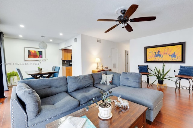 living room featuring ceiling fan and hardwood / wood-style flooring