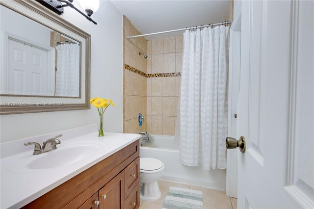 full bathroom featuring toilet, shower / bathtub combination with curtain, vanity, and tile patterned floors