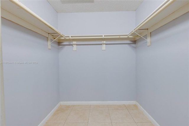 spacious closet with light tile patterned floors