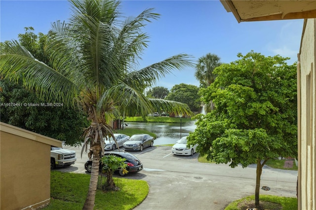 view of car parking with a water view