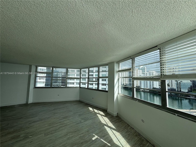 interior space featuring light hardwood / wood-style floors and a textured ceiling