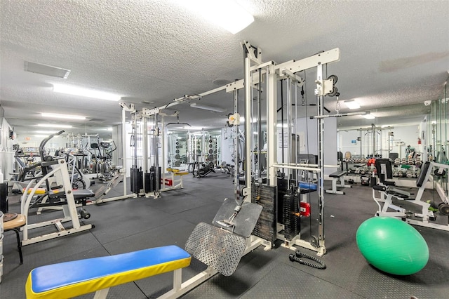 exercise room featuring a textured ceiling