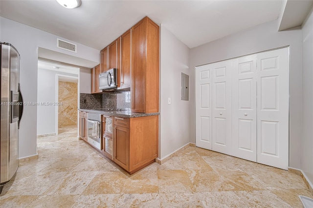 kitchen featuring decorative backsplash, electric panel, and stainless steel appliances