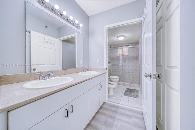 bathroom featuring vanity, toilet, walk in shower, and a bidet